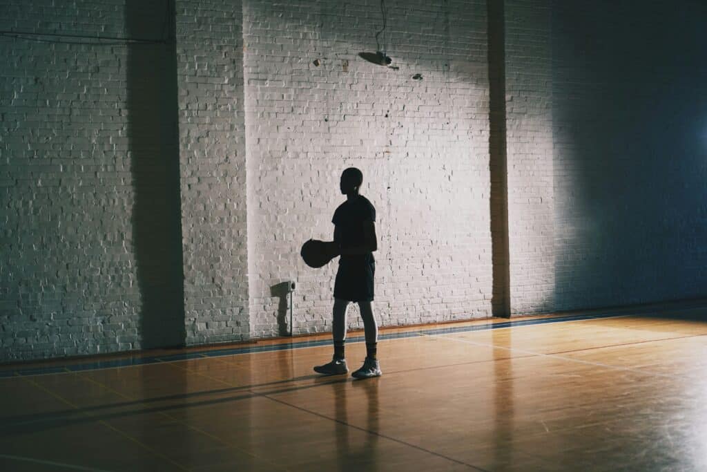 person playing basketball in gym